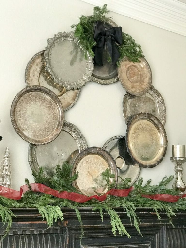 large wreath made of overlapping vintage silver trays and platters