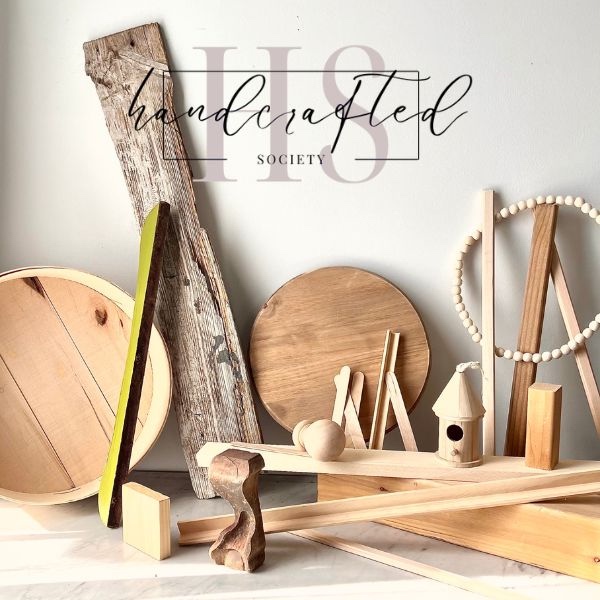 Wide assortment of wood and things made of wood with a logo for the Handcrafted Society