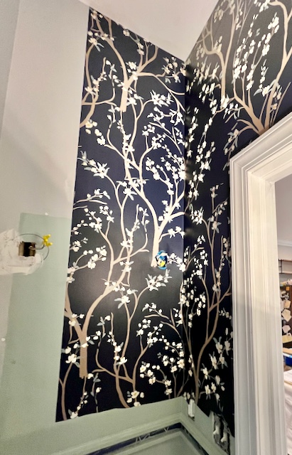 view of a partial wall and one corner covered in the new dramatic wallpaper