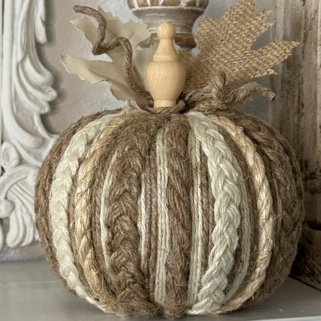 Pumpkin made with multiple different twines and jute and topped with a wood finial for a stem