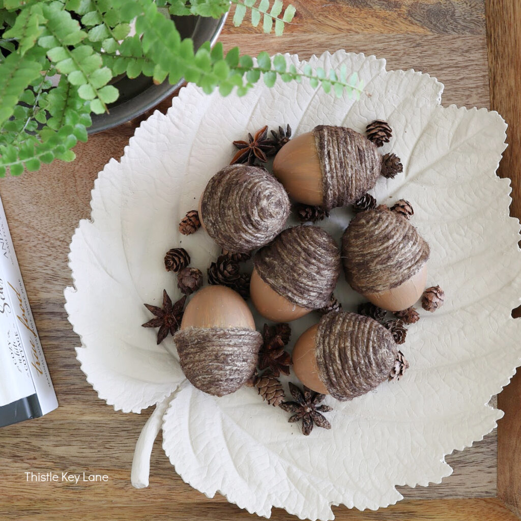 crafted acorns on a white leaf-shaped plate