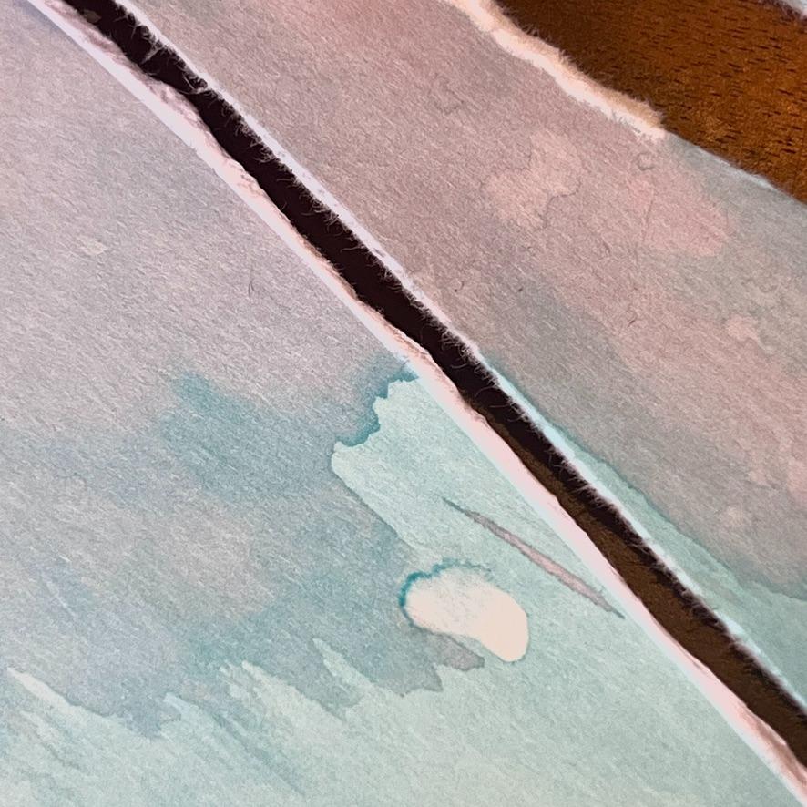 Close-up of two sheets of paper with a watercolor wash, each torn along the edge, revealing the rough white fibers and creating a textured, abstract composition in soft pastel colors.