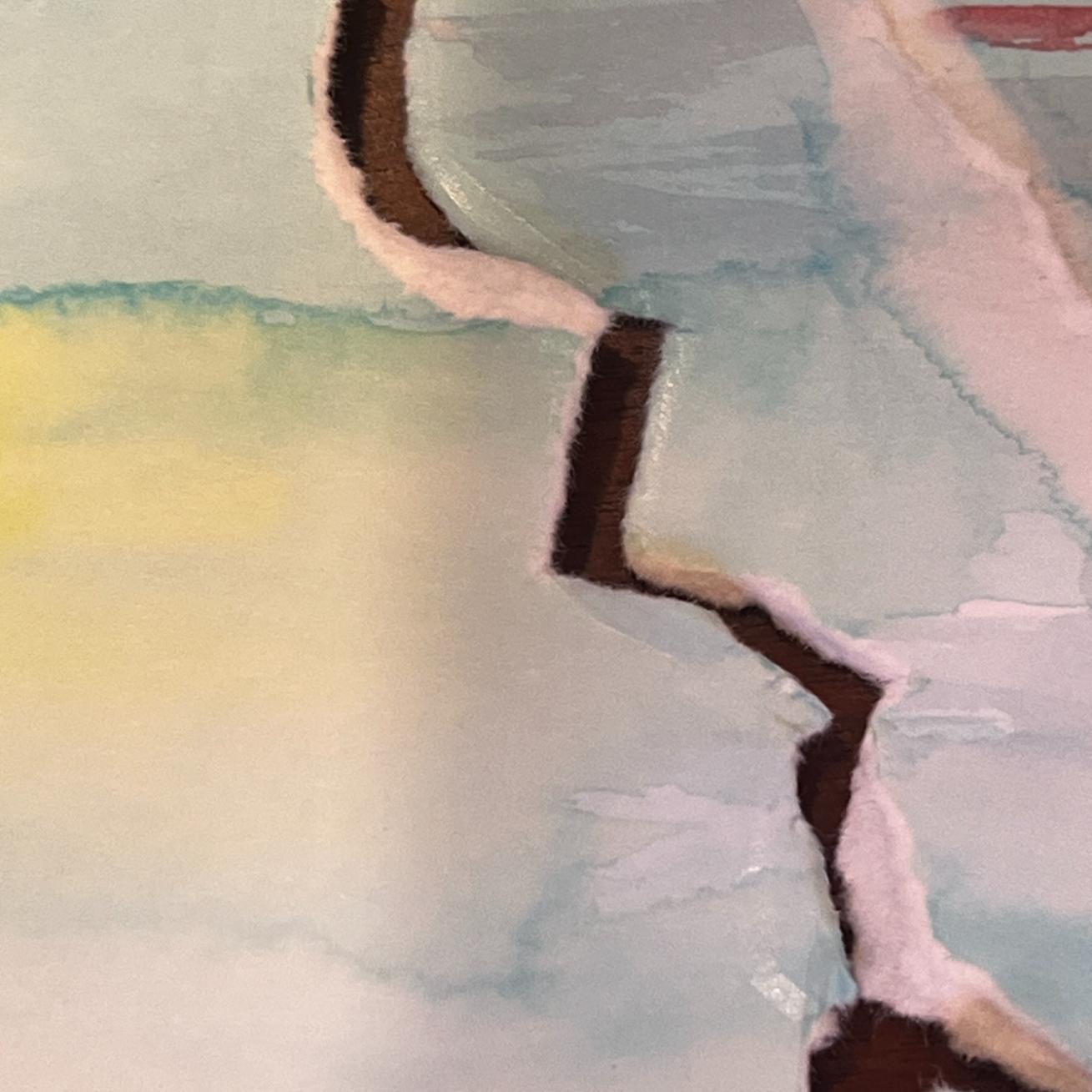 A close-up of torn paper with jagged, uneven edges, revealing a dark brown layer beneath. The top paper has soft pastel colors, including pale blue, pink, yellow, and green, with a watercolor-like texture.