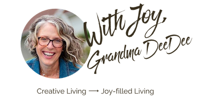 Smiling older woman with curly gray hair and glasses. Text reads: “With Joy, Grandma DeeDee.” Below: “Creative Living → Joy-filled Living.” Add a splash of inspiration to your home with Grandma DeeDee’s favorite accent wall paint idea, turning every day into a joy-filled moment.