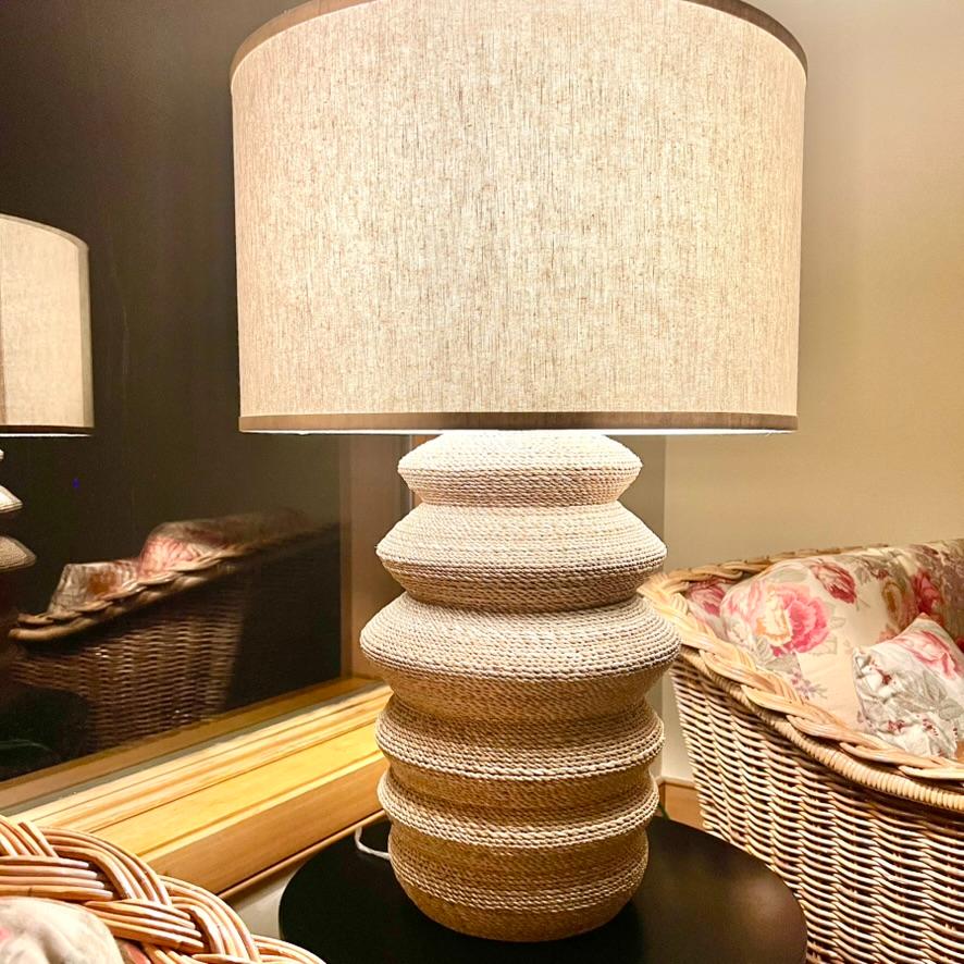 Table lamp with a textured drum shade and a stacked, rope-wrapped base.