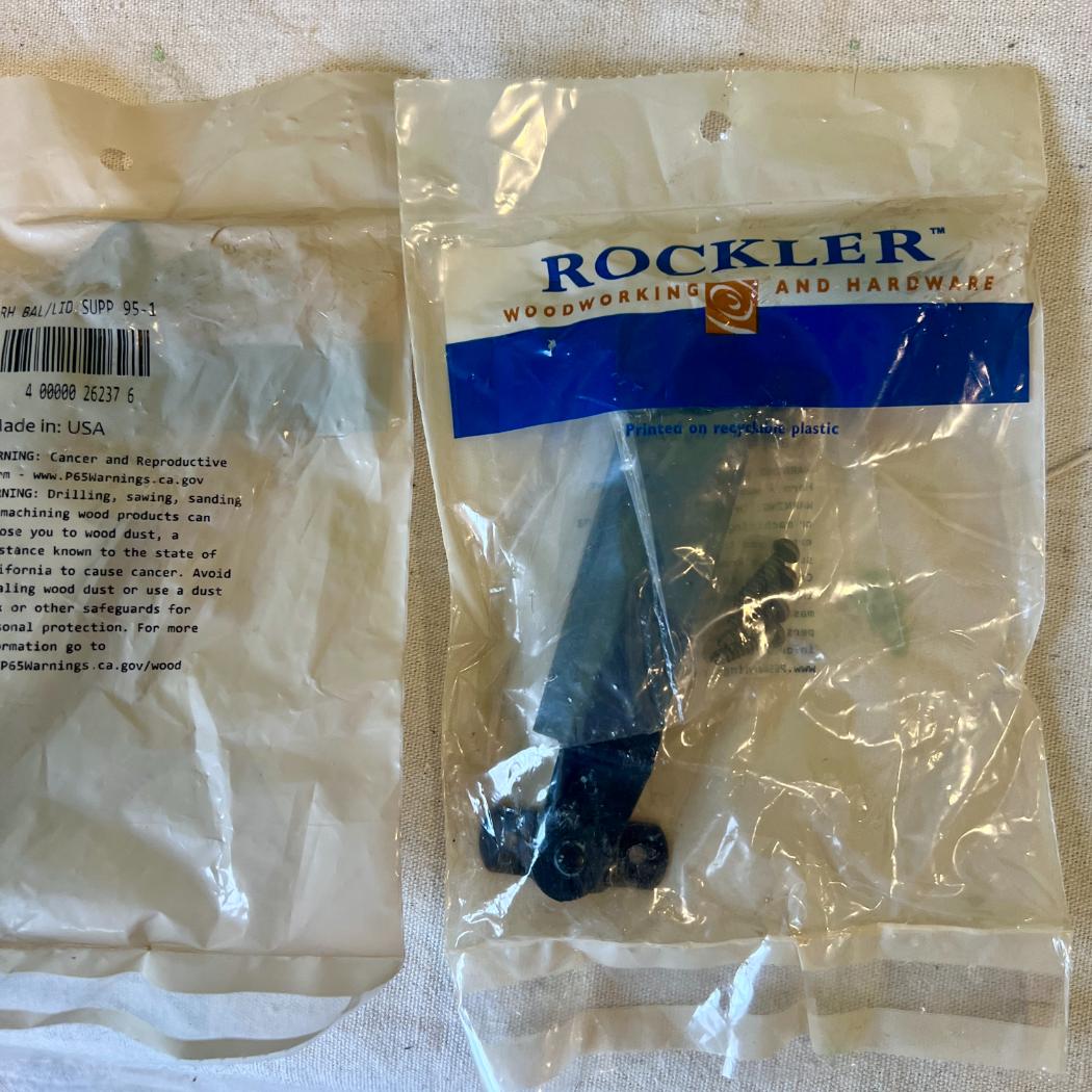 Two Rockler woodworking hardware packages in clear plastic bags, ideal for DIY storage above Pax wardrobes.